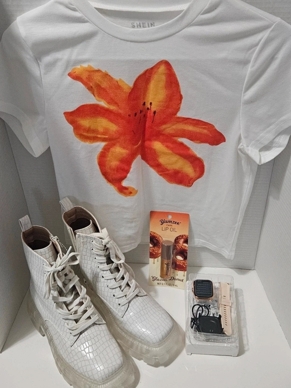 SHEIN White Tee, White Ankle Boots, Yumzee Lip Oil, Smart Watch.